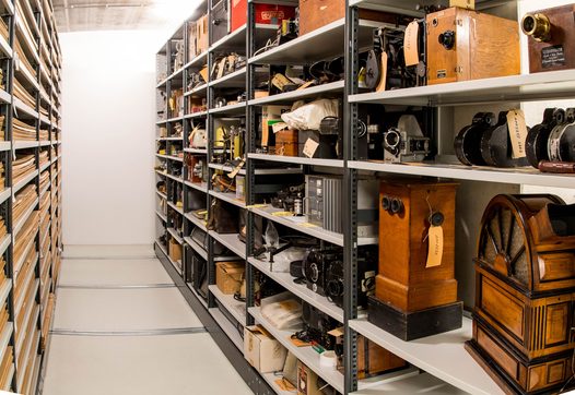 A variety of old film equipment is pictured in an open shelving unit in the Eye Collection Centre
